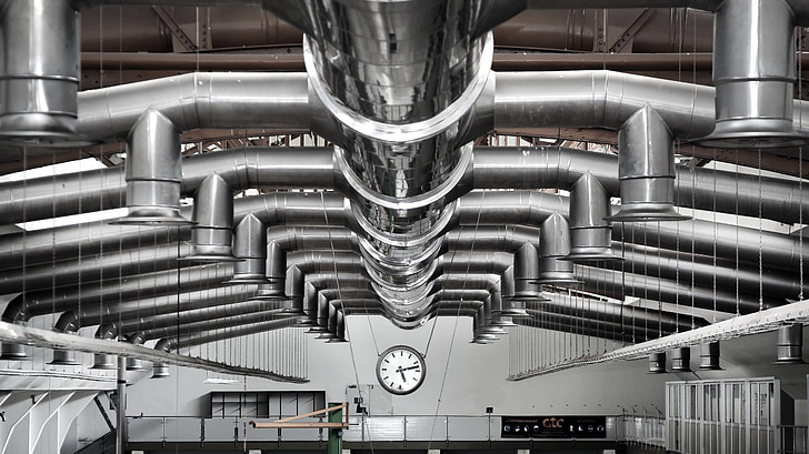 Finished metal ductwork installation running across an industrial ceiling